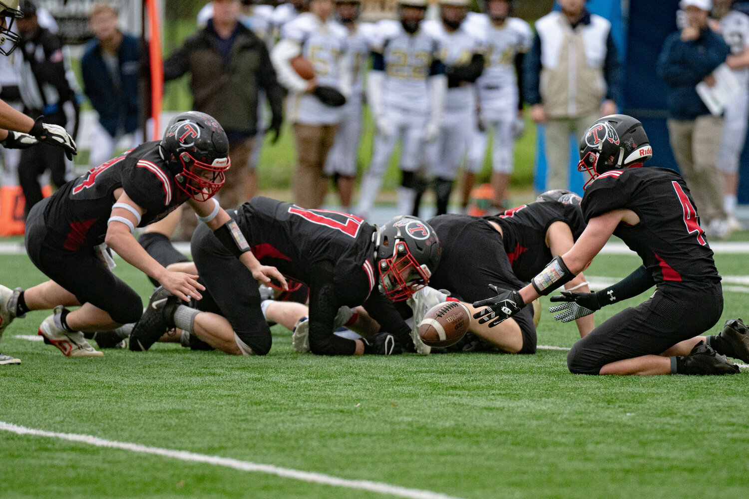 The Toledo defense recovers a fumble  during a 21-12 win over Tri Cities Prep Nov. 11.